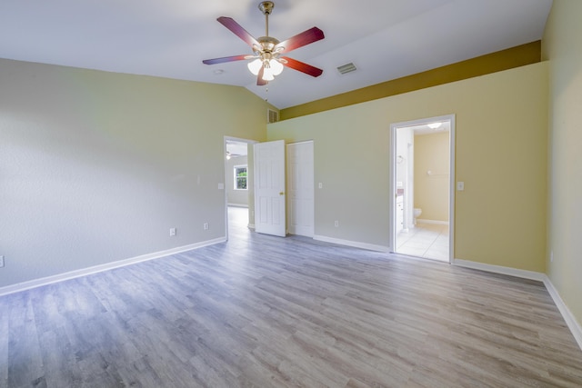 unfurnished room featuring ceiling fan, light hardwood / wood-style flooring, and vaulted ceiling