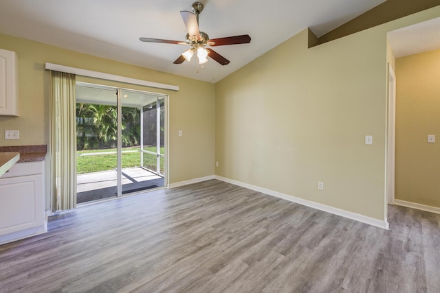 unfurnished living room featuring ceiling fan, lofted ceiling, and light wood-type flooring