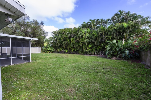 view of yard with a sunroom