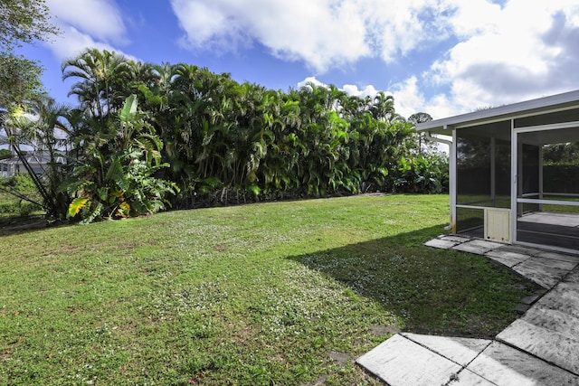 view of yard with a sunroom