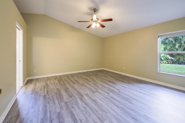 spare room featuring ceiling fan, lofted ceiling, and light hardwood / wood-style flooring