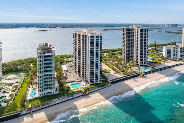 drone / aerial view with a water view and a beach view