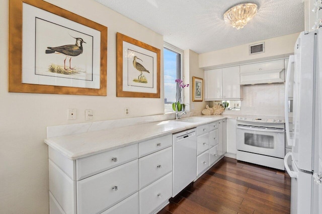 kitchen featuring white cabinetry, sink, dark wood-type flooring, a textured ceiling, and white appliances