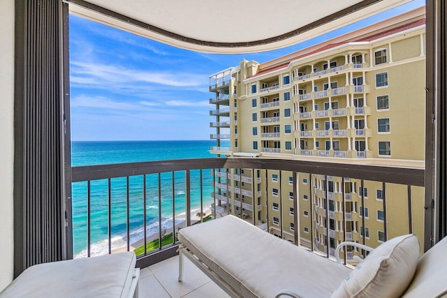 balcony featuring a water view and a beach view