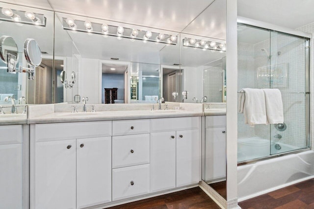 bathroom with vanity, combined bath / shower with glass door, and hardwood / wood-style flooring