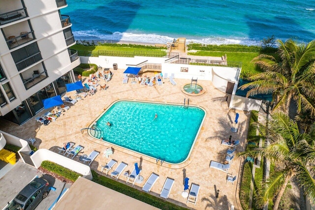 view of swimming pool featuring a beach view and a water view