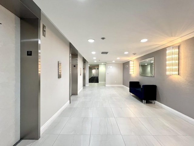 hallway featuring elevator and crown molding