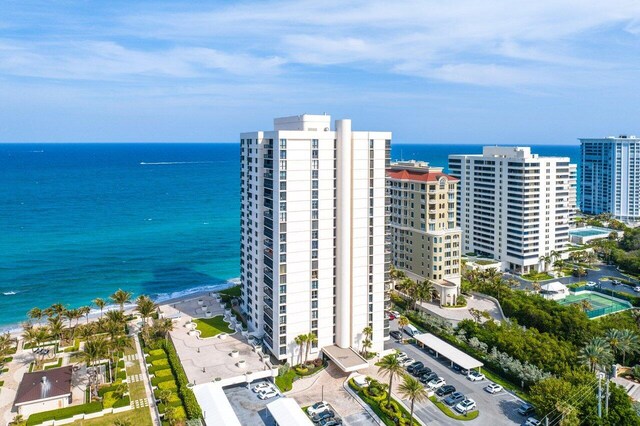 birds eye view of property with a water view and a view of the beach