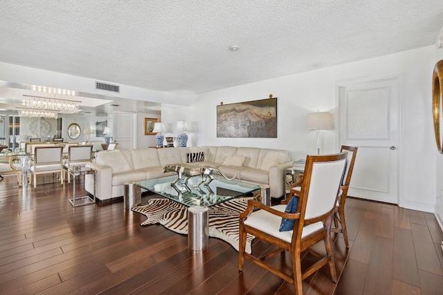 living room with dark hardwood / wood-style flooring and a textured ceiling