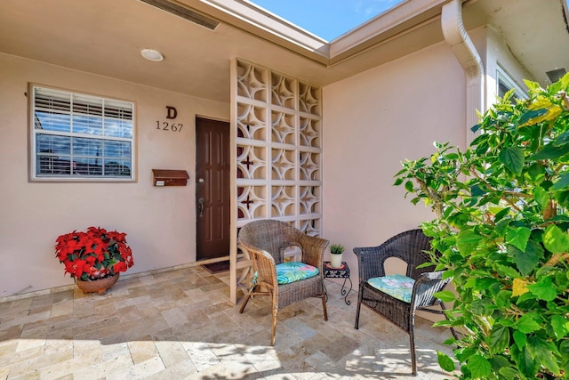 entrance to property featuring a patio