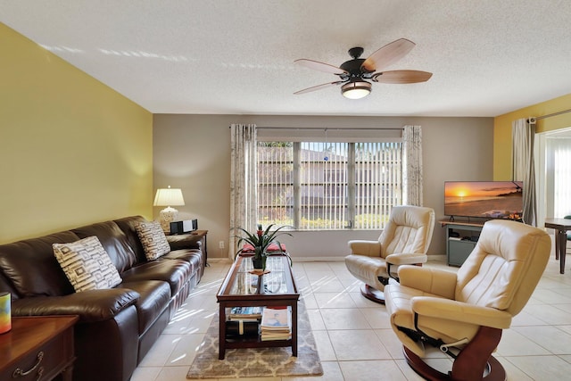 tiled living room featuring ceiling fan and a textured ceiling