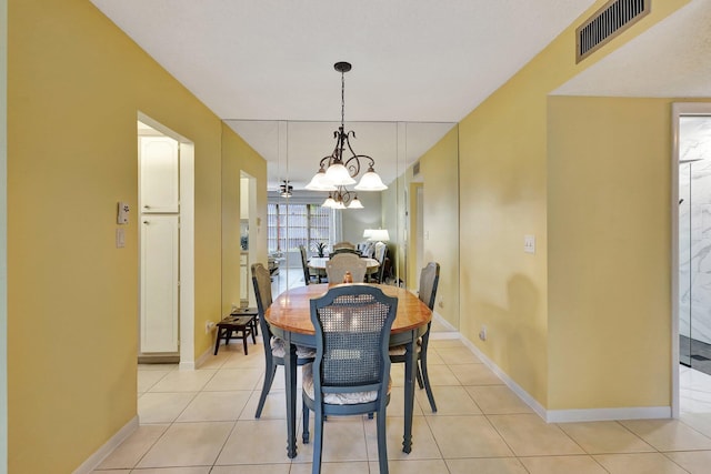 dining space featuring a notable chandelier and light tile patterned flooring