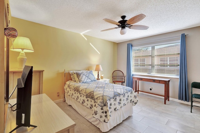 bedroom featuring ceiling fan and a textured ceiling