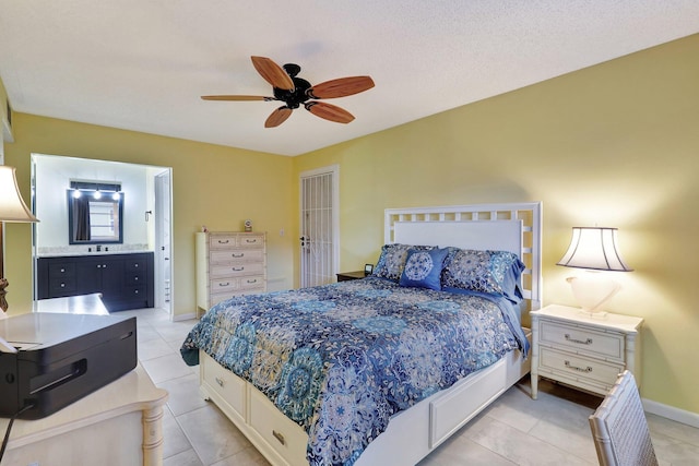 tiled bedroom featuring ensuite bath and ceiling fan