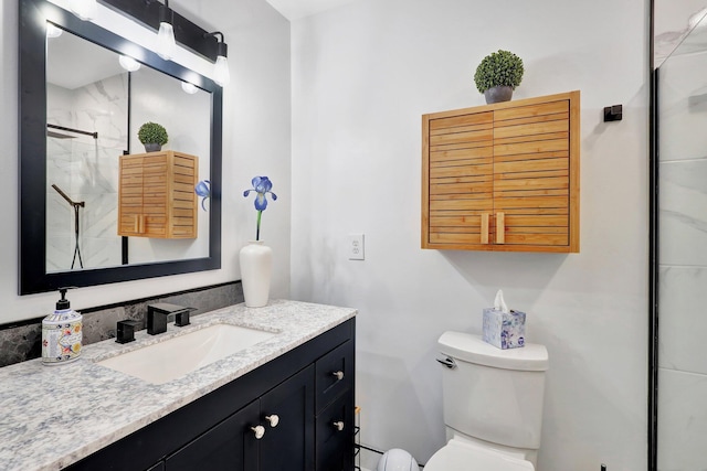 bathroom featuring vanity, toilet, and walk in shower