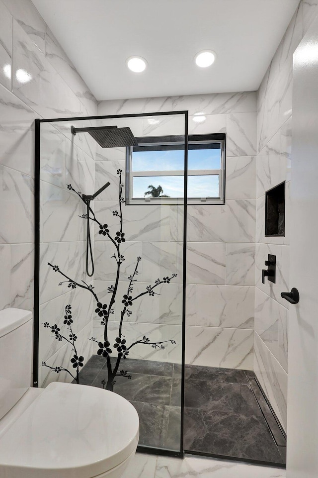 bathroom with toilet and a shower with door