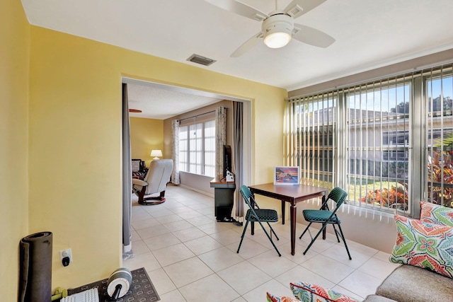 tiled dining space featuring ceiling fan