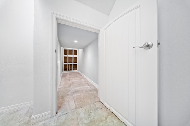 hall featuring vaulted ceiling