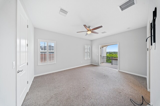 bedroom with access to outside, ceiling fan, light carpet, and multiple windows