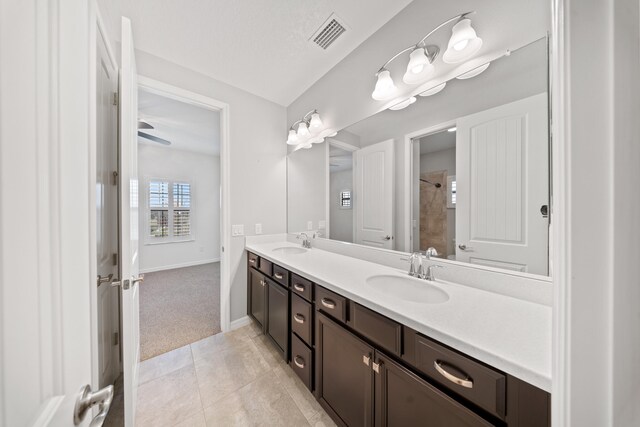 unfurnished bedroom featuring a textured ceiling, ceiling fan, ensuite bathroom, and a closet