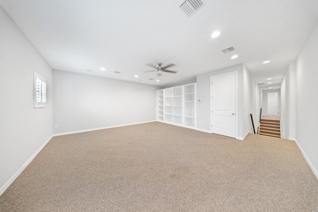 carpeted spare room with ceiling fan