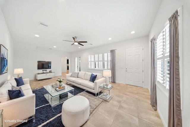 living room with ceiling fan and light tile patterned floors