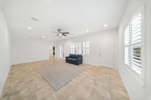 foyer featuring ceiling fan, light tile patterned floors, and a healthy amount of sunlight