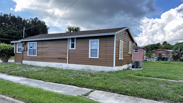 view of property exterior featuring a lawn and central air condition unit