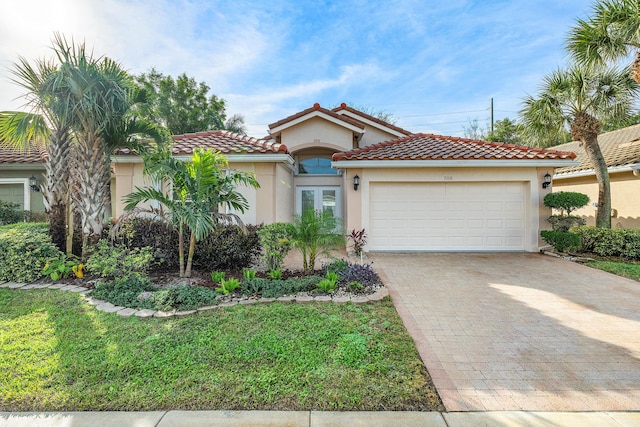 mediterranean / spanish-style house with a garage