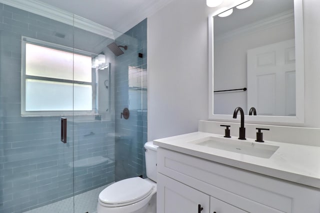 bathroom with vanity, toilet, ornamental molding, and walk in shower