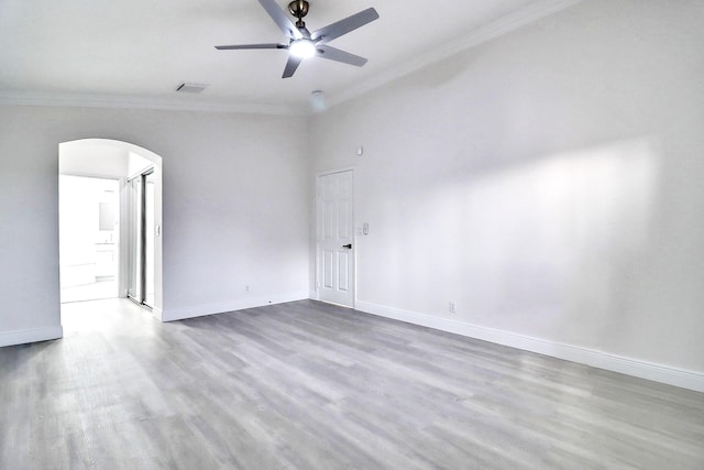 empty room with crown molding, hardwood / wood-style floors, and ceiling fan