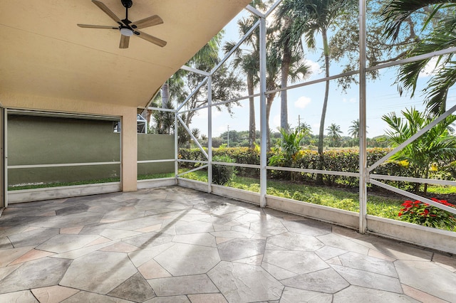 unfurnished sunroom with ceiling fan