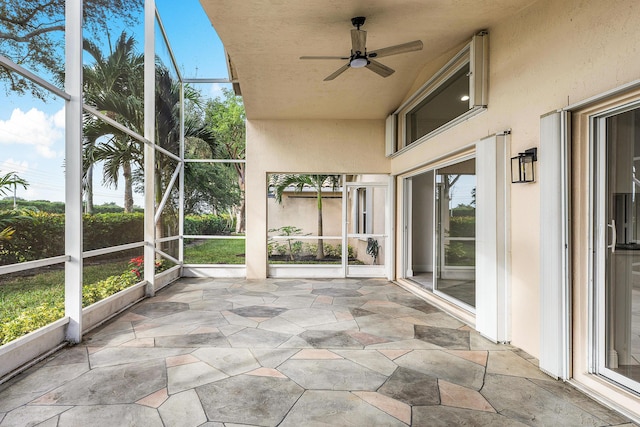 unfurnished sunroom with ceiling fan and plenty of natural light