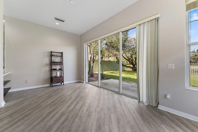 unfurnished room featuring hardwood / wood-style flooring