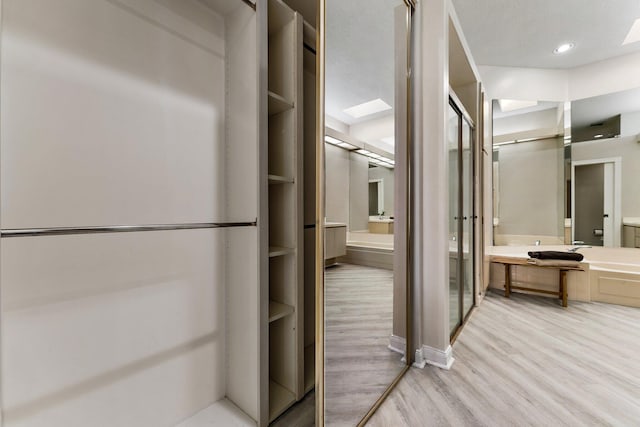 bathroom featuring built in shelves and wood-type flooring