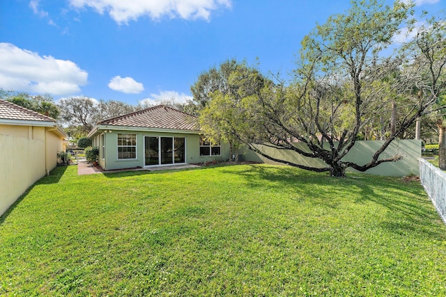 rear view of property featuring a yard