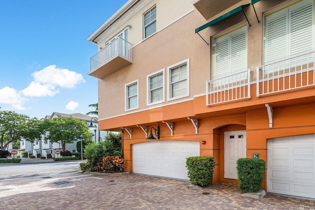 view of front facade with a balcony and a garage