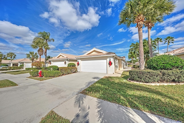 mediterranean / spanish-style home with a garage and a front yard