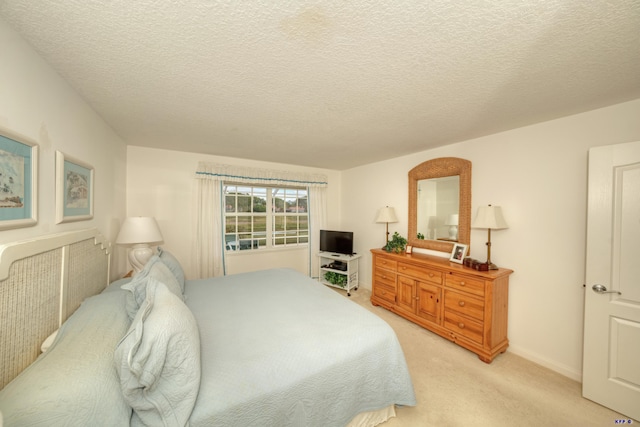 carpeted bedroom with a textured ceiling