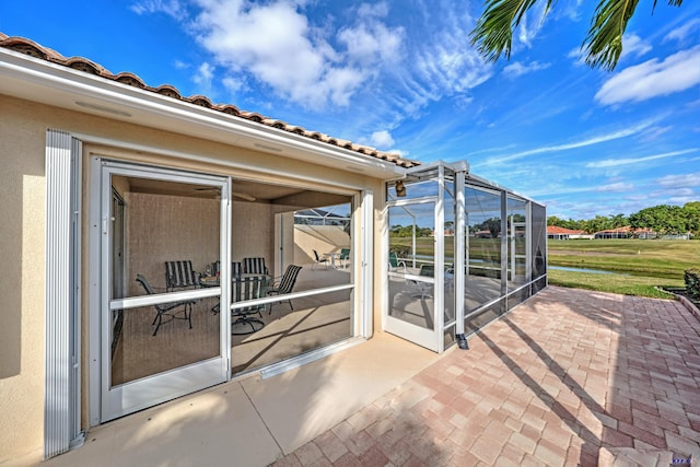 view of patio / terrace featuring glass enclosure