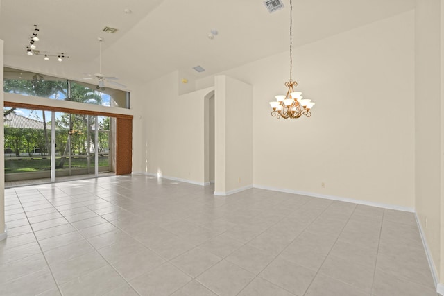 empty room with light tile patterned floors, visible vents, high vaulted ceiling, and ceiling fan with notable chandelier