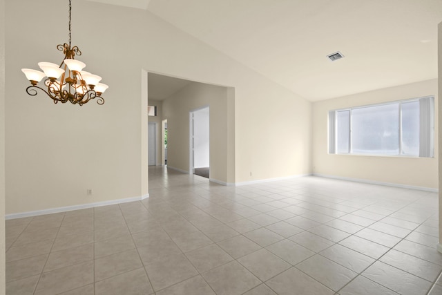 empty room featuring light tile patterned floors, a notable chandelier, visible vents, baseboards, and vaulted ceiling