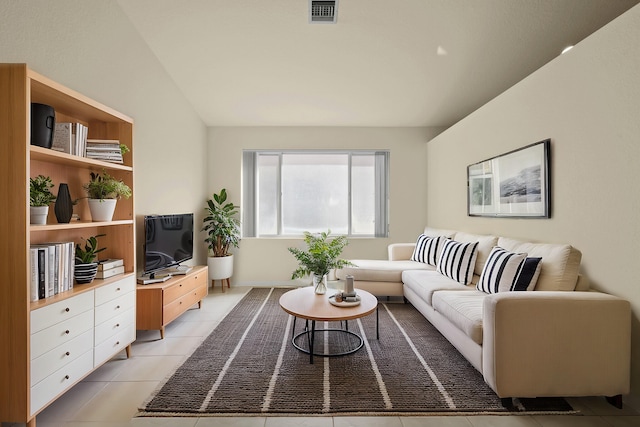 living room with visible vents, vaulted ceiling, and light tile patterned floors