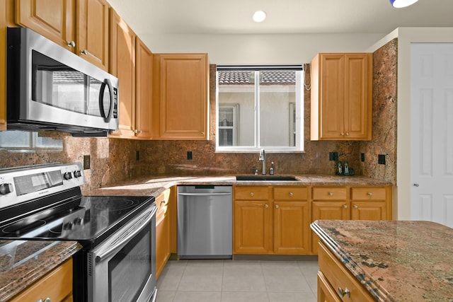 kitchen with tasteful backsplash, sink, appliances with stainless steel finishes, and dark stone counters