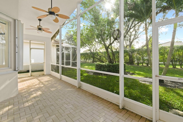 unfurnished sunroom with a ceiling fan