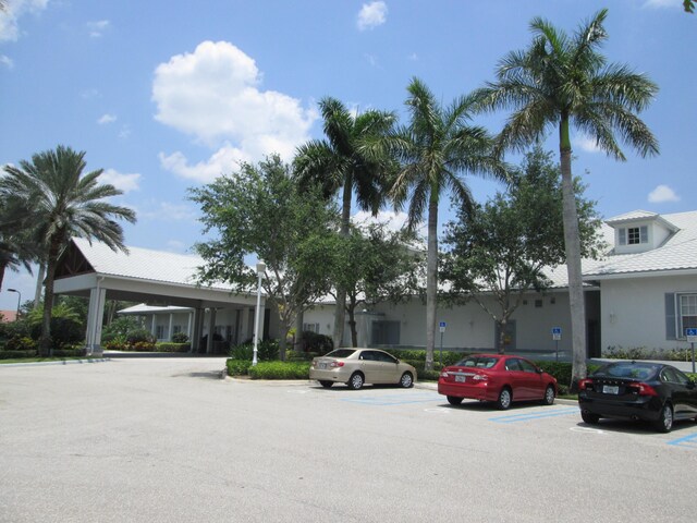 view of front facade with a carport and a front yard