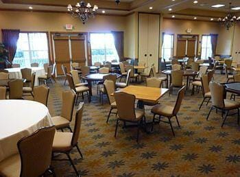 dining area featuring a chandelier, dark colored carpet, a tray ceiling, and recessed lighting