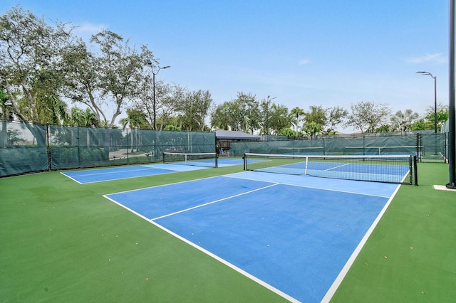 view of sport court featuring fence