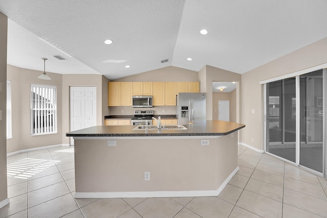 kitchen featuring sink, light tile patterned flooring, a center island with sink, and appliances with stainless steel finishes