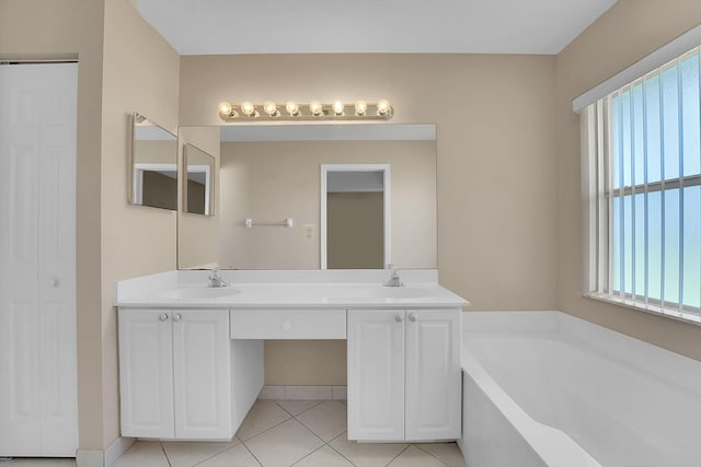 bathroom featuring tile patterned flooring, vanity, and a tub